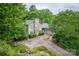 Scenic view of the home with lush greenery, a stone chimney and long driveway at 40 Old Rd, Taylorsville, NC 28681
