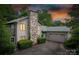 Charming home featuring a stone chimney, attached garage, and lush landscaping at 40 Old Rd, Taylorsville, NC 28681