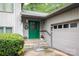 Inviting front entrance with green door, stone steps, and lush landscaping at 40 Old Rd, Taylorsville, NC 28681