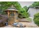 Lovely gazebo with blue potted plants by the side of the house with mature trees at 40 Old Rd, Taylorsville, NC 28681