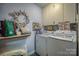 Functional laundry room featuring modern appliances, storage cabinets, and decor at 40 Old Rd, Taylorsville, NC 28681