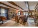 Cozy living room features a stone fireplace, wood paneled walls and beamed ceiling at 40 Old Rd, Taylorsville, NC 28681
