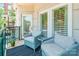 Relax on this covered balcony featuring comfortable seating and beautiful architectural details at 401 N Church St # 201, Charlotte, NC 28202