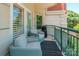 Relax on this covered balcony featuring comfortable seating and beautiful architectural details at 401 N Church St # 201, Charlotte, NC 28202