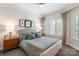 Comfortable bedroom with neutral tones and a window providing natural light at 401 N Church St # 201, Charlotte, NC 28202