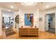 Elegant foyer with hardwood floors, a stylish console table, lamps, and an arched entry to the living space at 401 N Church St # 201, Charlotte, NC 28202