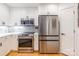 Updated kitchen features white cabinets, stainless steel appliances, and modern backsplash at 401 N Church St # 201, Charlotte, NC 28202