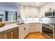 Bright kitchen featuring stainless steel appliances, granite counters, and undermount lighting at 401 N Church St # 201, Charlotte, NC 28202