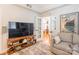 Living room with a sofa, television, and open doorway to the dining area at 401 N Church St # 201, Charlotte, NC 28202