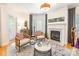 Comfortable living room featuring hardwood floors, a fireplace, neutral decor, and lots of natural light at 401 N Church St # 201, Charlotte, NC 28202