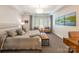 Relaxing main bedroom featuring a plush bed, seating area, and large windows with natural light at 401 N Church St # 201, Charlotte, NC 28202
