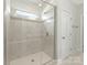 Bathroom featuring a glass shower with subway tile and bench at 4305 Twenty Grand Dr, Indian Trail, NC 28079