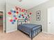 Bright bedroom with a metal frame bed, geometric art on the wall, neutral paint, and carpet flooring at 4305 Twenty Grand Dr, Indian Trail, NC 28079