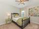 Cozy bedroom with a black frame bed, colorful pillows, and a stylish ceiling fan with a light fixture at 4305 Twenty Grand Dr, Indian Trail, NC 28079