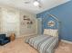 Charming bedroom with a house frame bed, blue accent wall, neutral paint, and a cozy sitting chair at 4305 Twenty Grand Dr, Indian Trail, NC 28079