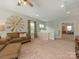 Upstairs bonus room with comfortable seating and decorative windmill art at 4305 Twenty Grand Dr, Indian Trail, NC 28079
