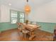 Elegant dining room featuring hardwood floors, decorative lighting, and a bright window at 4305 Twenty Grand Dr, Indian Trail, NC 28079