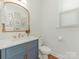 Stylish half bathroom with modern fixtures, a decorative mirror, and a clean, bright design at 4305 Twenty Grand Dr, Indian Trail, NC 28079