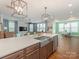 Open concept kitchen with a spacious island, stainless steel appliances, and views into the living and dining areas at 4305 Twenty Grand Dr, Indian Trail, NC 28079