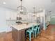 Modern kitchen featuring a large island with seating, stainless steel appliances, and stylish pendant lights at 4305 Twenty Grand Dr, Indian Trail, NC 28079