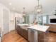 Bright kitchen with a large island, stainless steel appliances, and an open design leading to the living area at 4305 Twenty Grand Dr, Indian Trail, NC 28079