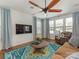 Comfortable living room with hardwood floors, ample natural light, and a large ceiling fan at 4305 Twenty Grand Dr, Indian Trail, NC 28079