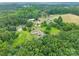 Aerial view of a property featuring multiple buildings and a surrounding landscape of trees at 4373 Wentz Rd, Maiden, NC 28650