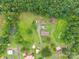 Overhead shot of a property with a green lawn, outbuildings, and mature trees surrounding the area at 4373 Wentz Rd, Maiden, NC 28650
