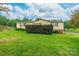 Nice view of a backyard with a lush green lawn and mature shrubbery around the house at 4373 Wentz Rd, Maiden, NC 28650