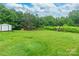 Large backyard featuring green grass, trees, playset and storage shed at 4373 Wentz Rd, Maiden, NC 28650
