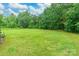 Spacious backyard featuring green grass, shade trees, and open space at 4373 Wentz Rd, Maiden, NC 28650