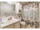 Bathroom with floral wallpaper, neutral-toned sink, vanity, and shower/tub combo at 4373 Wentz Rd, Maiden, NC 28650