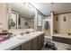 A bathroom with double sinks, a shower, and a separate tub, all accented by neutral tones and trim at 4373 Wentz Rd, Maiden, NC 28650