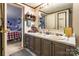 Bathroom featuring double sinks, cabinets, and a mirror, with a partial view into a bedroom at 4373 Wentz Rd, Maiden, NC 28650