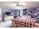 This bedroom includes a plaid bedspread, white dressers, and a TV mounted on the wall at 4373 Wentz Rd, Maiden, NC 28650
