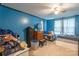 Bedroom with blue walls, ceiling fan, and window providing natural light at 4373 Wentz Rd, Maiden, NC 28650