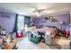 A bedroom with lavender walls, a plaid bedspread, and a collection of personal items around the room at 4373 Wentz Rd, Maiden, NC 28650