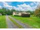 Charming single-story home with a gravel driveway and well-maintained lawn and mature landscaping at 4373 Wentz Rd, Maiden, NC 28650
