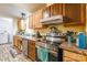 This angle features a kitchen with wooden cabinetry, appliances, and countertops, creating a functional cooking space at 4373 Wentz Rd, Maiden, NC 28650