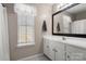 Bathroom with a large mirror, vanity, and window for a bright and inviting space at 4764 Brockton Nw Ct, Concord, NC 28027