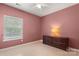 Cozy bedroom featuring neutral walls, ceiling fan, window, and dark dresser for comfort at 4764 Brockton Nw Ct, Concord, NC 28027