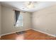 Neutral bedroom features wood floors, window, and ceiling fan for comfortable living at 4764 Brockton Nw Ct, Concord, NC 28027
