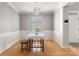 Bright dining room features hardwood floors, modern light fixture, and decorative wainscoting at 4764 Brockton Nw Ct, Concord, NC 28027
