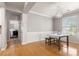 Well-lit dining room featuring hardwood floors, modern lighting, and wainscoting at 4764 Brockton Nw Ct, Concord, NC 28027