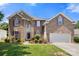 Beautiful two-story brick home with landscaped yard and a two-car garage with purple shutters and a mature lawn at 4764 Brockton Nw Ct, Concord, NC 28027
