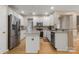 Spacious kitchen featuring white cabinets, granite countertops, stainless steel appliances, and hardwood flooring at 4764 Brockton Nw Ct, Concord, NC 28027