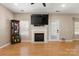 Bright living room featuring hardwood floors, a fireplace with mantle, and a ceiling fan at 4764 Brockton Nw Ct, Concord, NC 28027