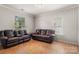 Inviting living room features tile flooring and two large windows offering ample natural light at 4764 Brockton Nw Ct, Concord, NC 28027