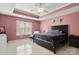 This home features a main bedroom with a ceiling fan, a window, and comfortable furniture at 4764 Brockton Nw Ct, Concord, NC 28027
