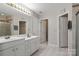 The primary bath features a large mirror, double sinks, and a tiled floor at 4764 Brockton Nw Ct, Concord, NC 28027